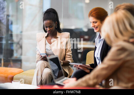 Business people conversation with technology at hand. Exchange of new ideas and brainstorming between colleagues Stock Photo