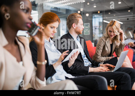 Business people conversation with technology at hand. Exchange of new ideas and brainstorming between colleagues Stock Photo