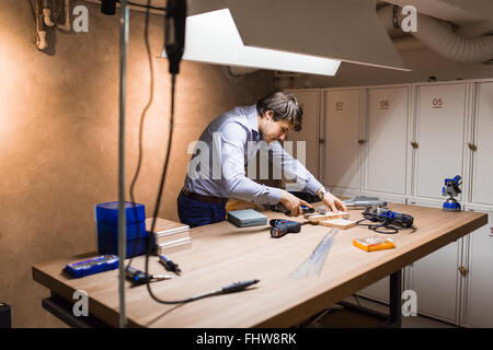 Joiner working and designing on workbench in workshop Stock Photo