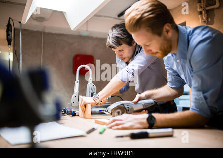 Two creative designers working in workshop and creating custom furniture Stock Photo