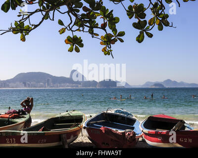 Fishing boats are moored on the beach of Nazaré. At one of the boats a ...