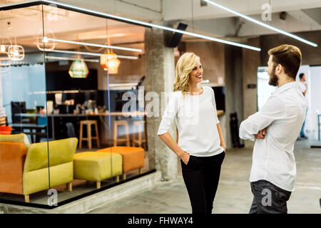 Beautiful saleswoman talking to customer and smiling Stock Photo