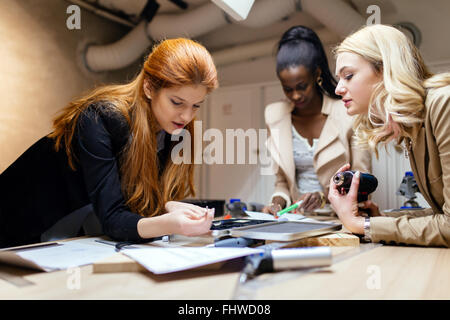 Team working on project together and sharing ideas in workshop Stock Photo