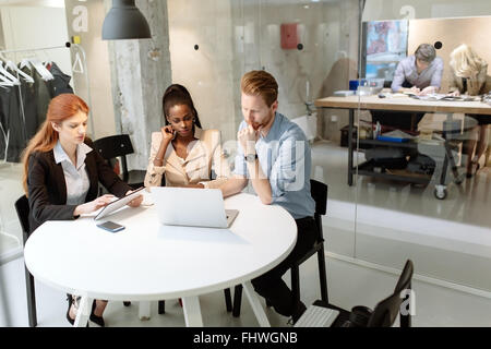 Business people board meeting in modern office while sitting at round table Stock Photo