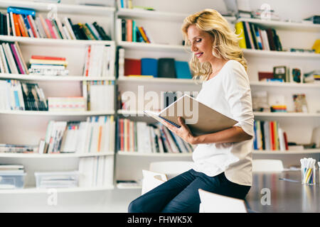 Stunning woman reading a book Stock Photo