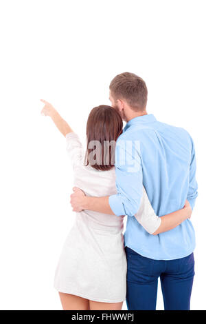 A young heterosexual couple, possibly just married, a wife and a husband standing together and hugging gently. They are shot fro Stock Photo