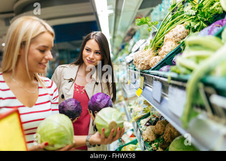 https://l450v.alamy.com/450v/fhwx98/beautiful-women-shopping-vegetables-and-fruits-in-supermarket-fhwx98.jpg