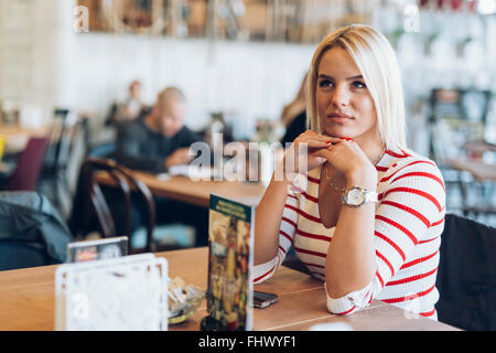 Portrait of beautiful blonde woman in cafe Stock Photo