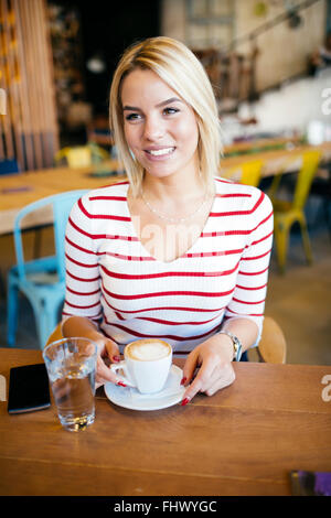 Beautiful woman enjoying beverages in nice cafe Stock Photo