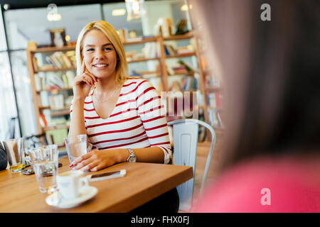 Beautiful woman drinking coffee in a wooden cafe Stock Photo