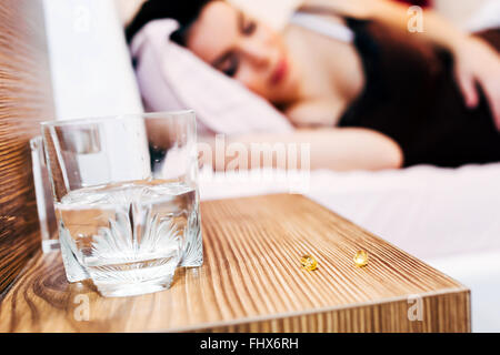 Pregnant woman resting with pills at hand for various aches Stock Photo