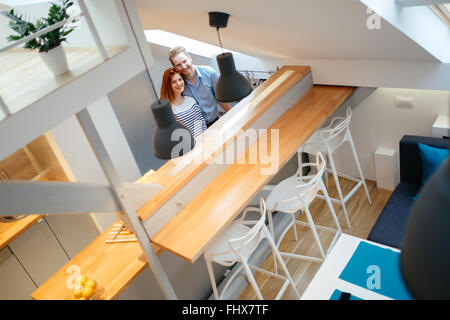 Beautiful couple posing in well designed kitchen Stock Photo