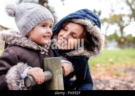 Portrait of happy little girl with her mother on a playground in autumn Stock Photo