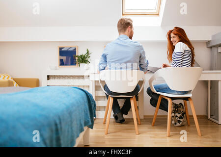 Beautiful couple working from clean nicely designed home Stock Photo