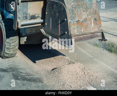 Milling of asphalt for road reconstruction accessory for skid steer Stock Photo
