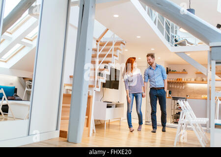 Couple moving in new apartment with smiles on their faces Stock Photo