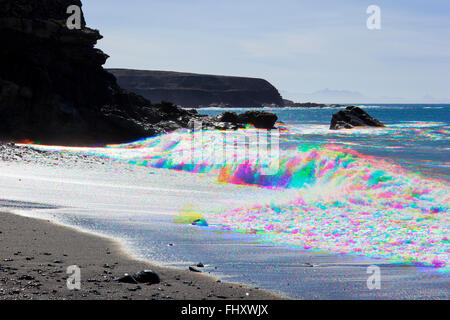 Combination photograph made of three colour-separated images of Atlantic waves breaking on the beach at Ajuy, Fuerteventura, Canary Islands, Spain Stock Photo