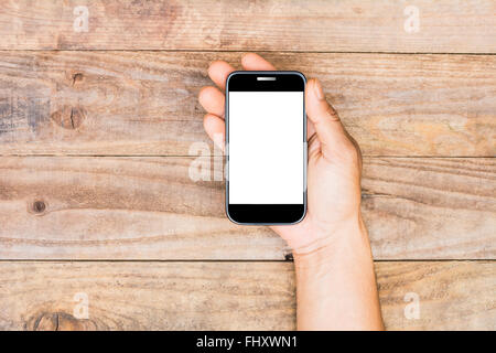 Smartphone in a male's hands on old wooden background Stock Photo