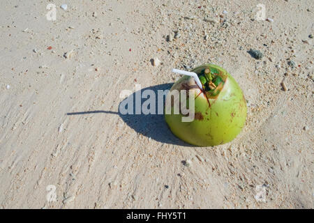 Fresh coconut drink on tropical white sandy beach Stock Photo
