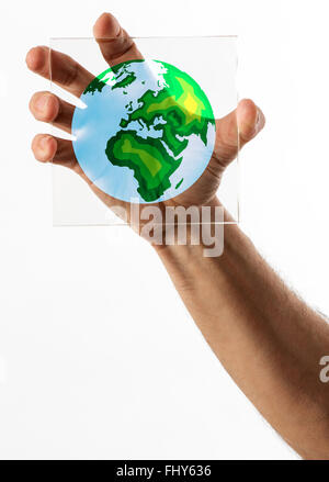 Planet Earth symbol on piece of square shaped glass held in a single hand over white background Stock Photo