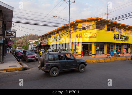 A street scene with beat up cars and a El Yerdugo store in Quepos, Puntarenas Province, Costa Rica. Stock Photo