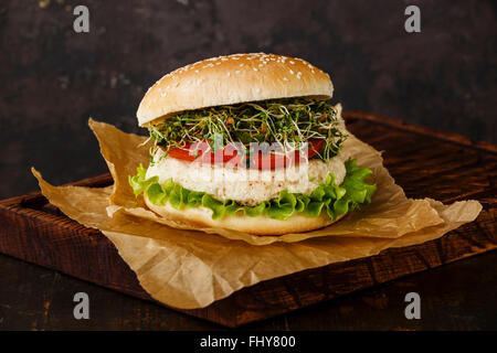 Cauliflower burger with clover sprouts on dark background Stock Photo