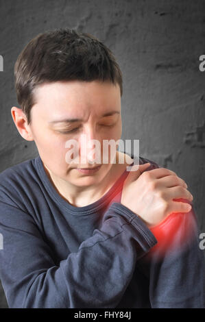 Woman with shoulder pain. Selective focus. Stock Photo
