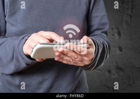 Hand holding smart phone, wifi icon appears on the screen of the phone. Selective focus.