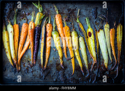 Rainbow carrots roasted on a pan. Stock Photo