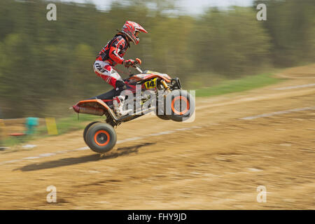 MOHELNICE,  CZECH REPUBLIC - APRIL 19: Racer in red is riding a quad motorbike in the 'International Championship of the Czech R Stock Photo