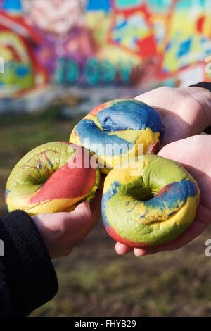 London, UK. 26th February, 2016. New York’s Rainbow bagels are now being sold in Brick Lane, London, UK. The multi coloured bagels are made from seven coloured dough mixtures. A traditional bagel filling is salmon and cream cheese. Three multi coloured Rainbow beigels. Stock Photo