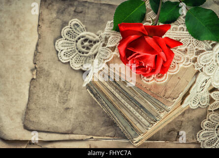 Old love letters, red rose flower and antique lace. Vintage toned picture Stock Photo
