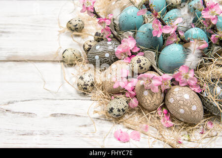 Easter decoration with blue eggs and pink flowers Stock Photo