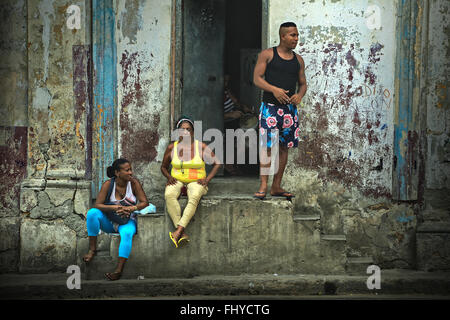 Cubans have a rest and talk on the street near the house, the Old Havana, Cuba Stock Photo