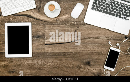 Office desk with laptop, coffee, digital tablet pc, smartphone. Home office on wooden table Stock Photo