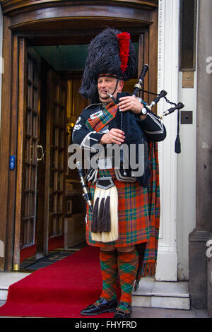 EDINBURGH, SCOTLAND, - MARCH 6: Unidentified Scottish Bagpiper playing music with bagpipe at Edinburgh on March 6, 2010. Edinbur Stock Photo