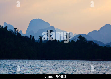 KARST FORMATIONS create an beautiful landscape around CHEOW EN LAKE in KHAO SOK NATIONAL PARK - THAILAND Stock Photo