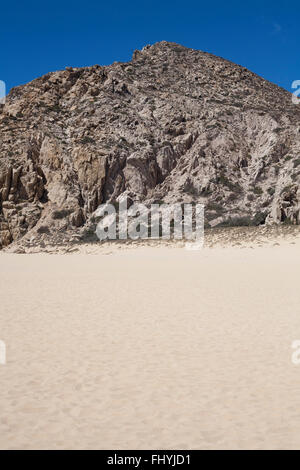 Cliffs loom over Lovers beach in Cabo San Lucas. Stock Photo