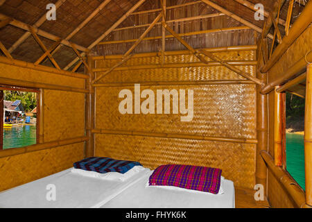 Interior of bedroom at NANG PRAI RAFT HOUSE on CHEOW EN LAKE in the KHAO SOK NATIONAL PARK - THAILAND Stock Photo