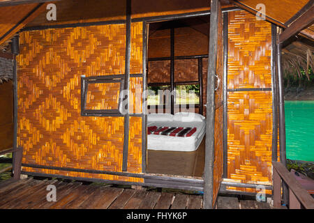 Interior of bedroom at NANG PRAI RAFT HOUSE on CHEOW EN LAKE in the KHAO SOK NATIONAL PARK - THAILAND Stock Photo