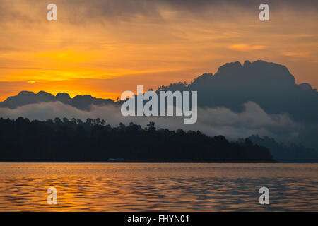 SUNSET on KLONG SAENG of CHEOW EN LAKE in KHAO SOK NATIONAL PARK - THAILAND Stock Photo