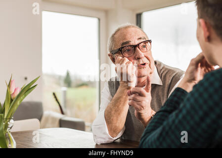 Portrait of senior man communicating with his grandson Stock Photo