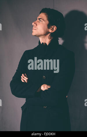 Fashionable young man in a black coat. Stock Photo