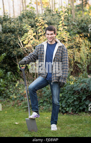 young man  working in garden with shovel Stock Photo