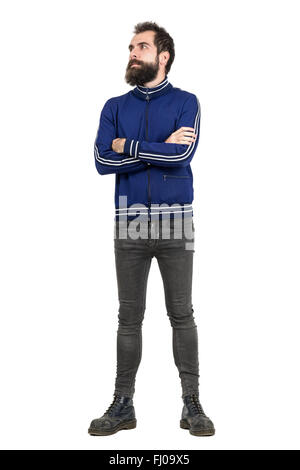Tough bearded guy wearing tracksuit jacket with crossed arms looking away. Full body length portrait isolated over white Stock Photo