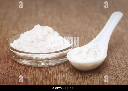 Baking powder in a glass bowl and spoon Stock Photo