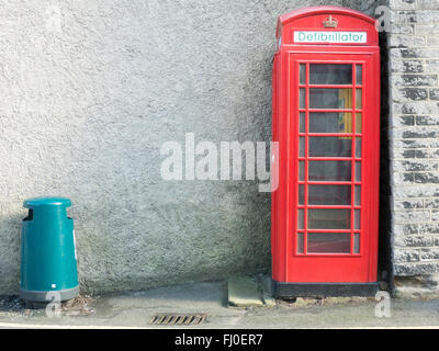 Traditional British red phone box converted to a defibrillator in Castleton, Derbyshire Stock Photo