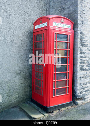 Traditional British red phone box converted to a defibrillator in Castleton, Derbyshire Stock Photo