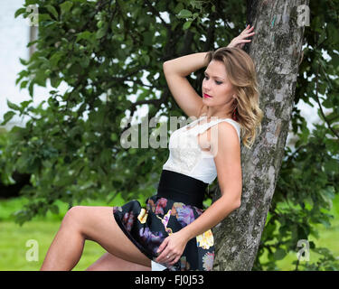 Girl student rests in the Park after school. Stock Photo