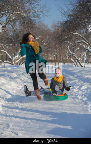Young lovers having fun in winter clothes in the Park.Christmas Stock Photo